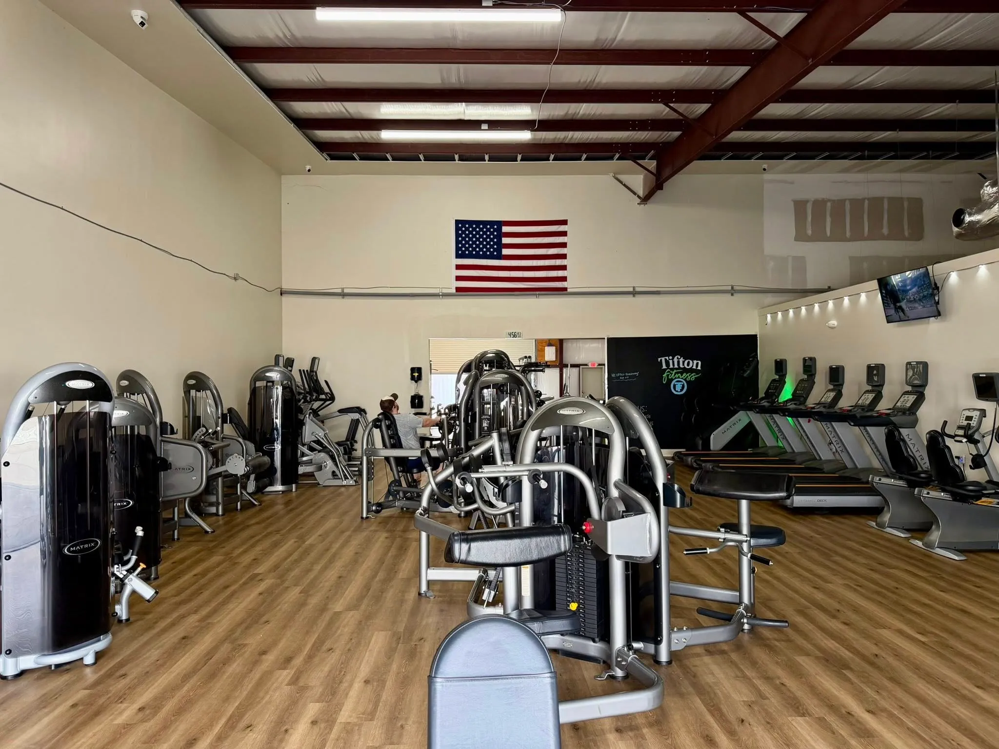 Inside Tifton Fitness — free weights, bench, and training floor